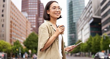 King's Marketing student holding a tablet in the city
